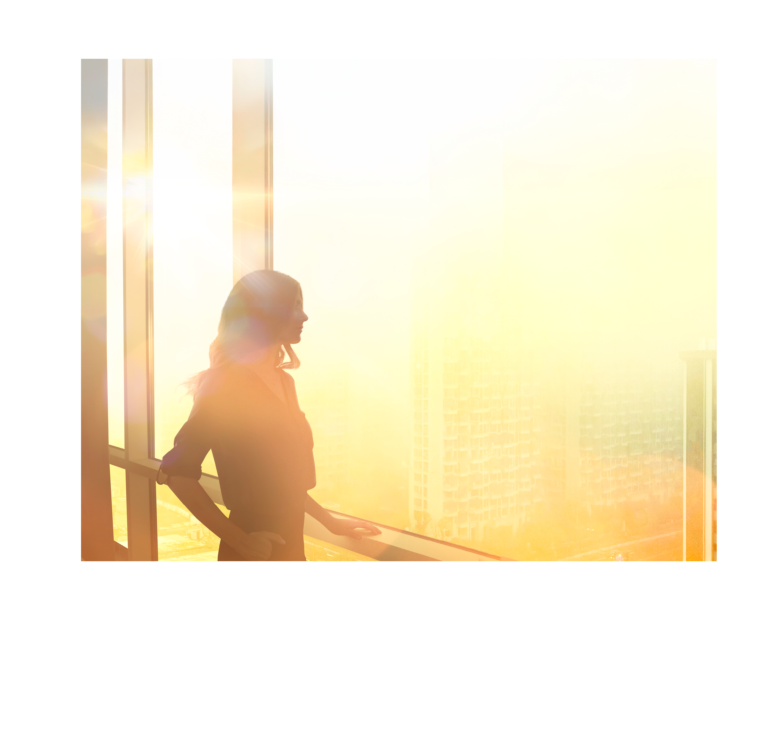 CEO woman looking out skyscraper window dreaming big
