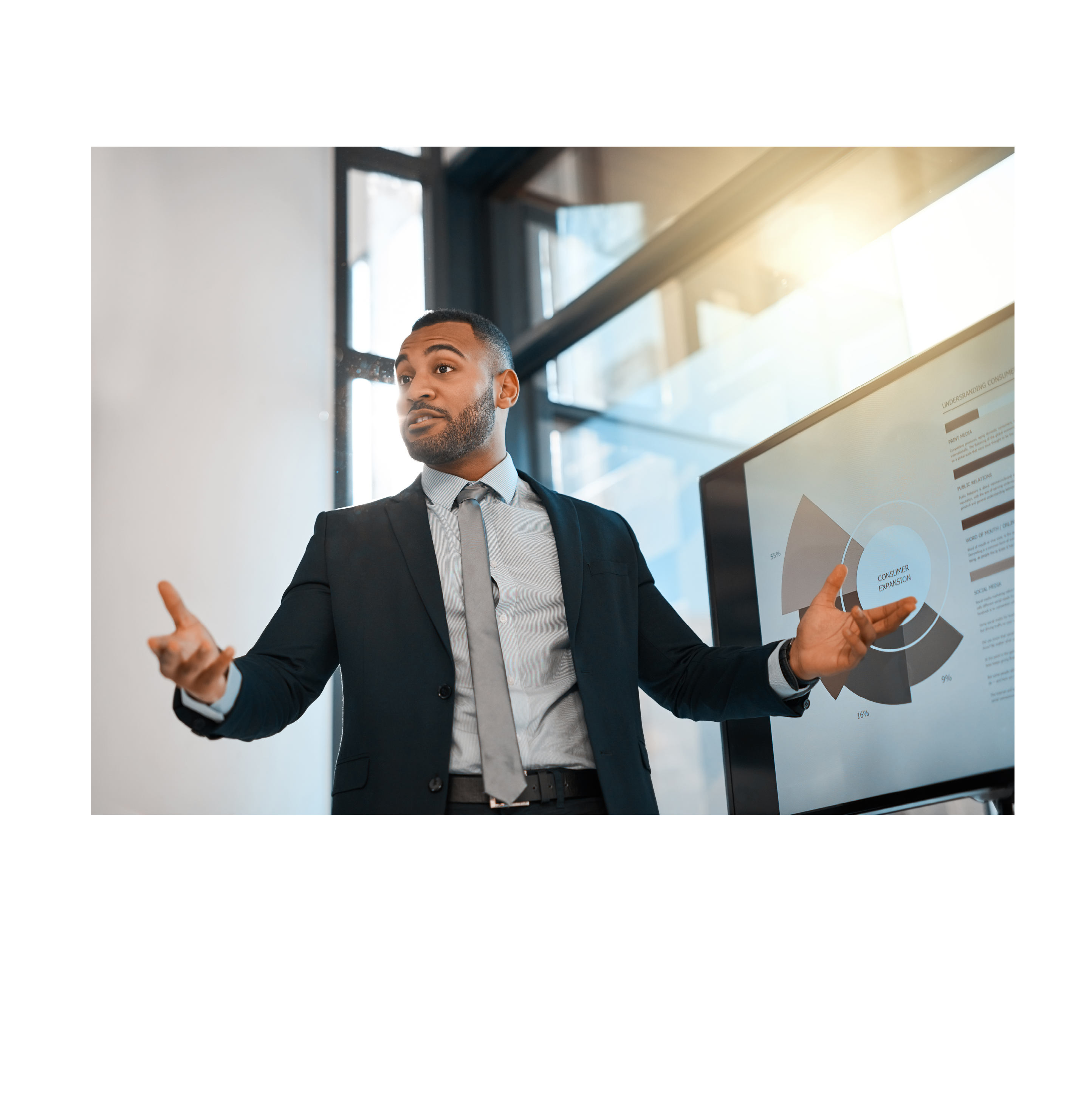 Shot of a young businessman presenting data on a screen during a meeting in an office