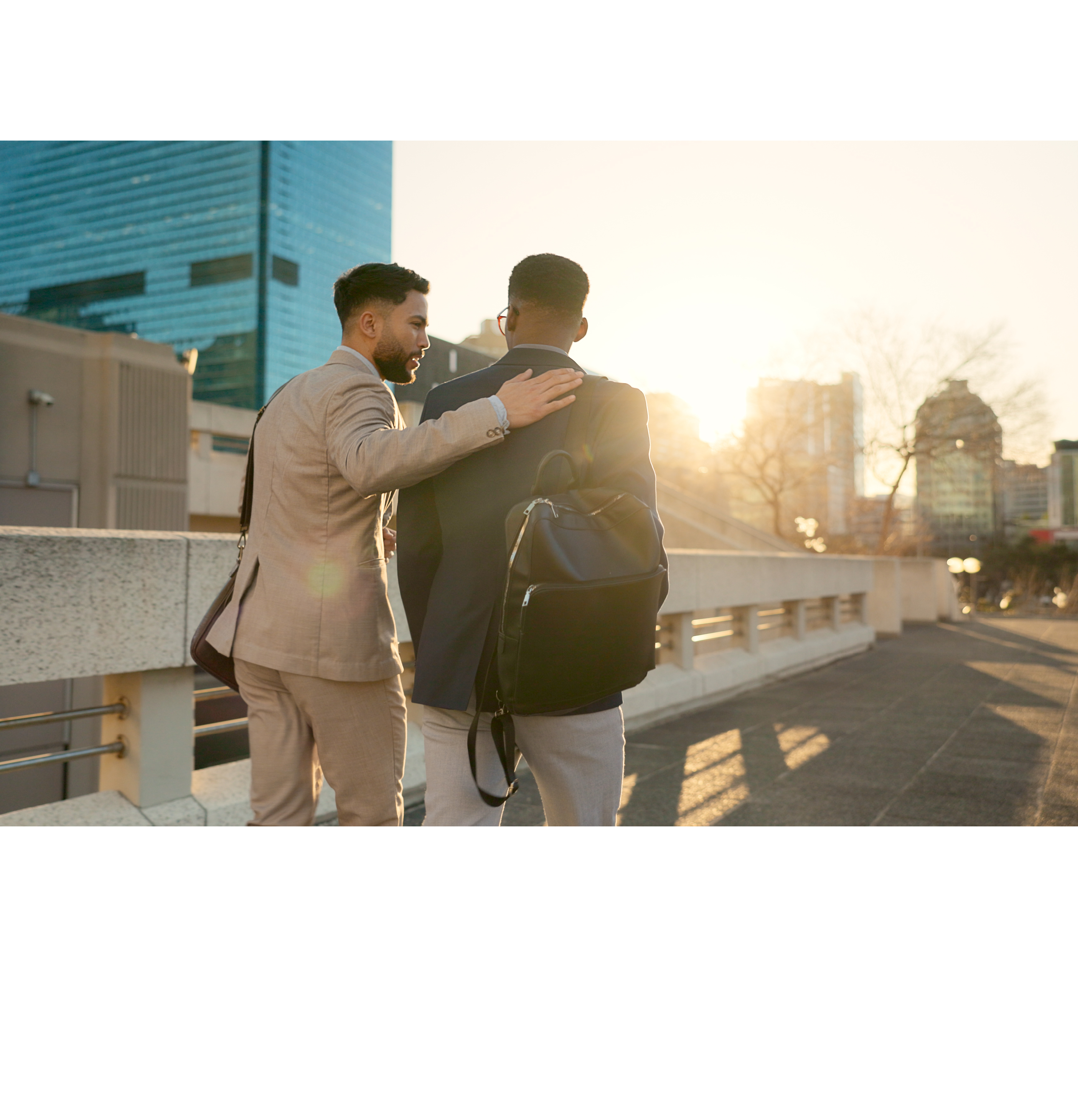 Business, men and walking in street with support in city for partnership, collaboration and teamwork. Professional, people and outdoor by buildings for travel, commute and conversation and diversity