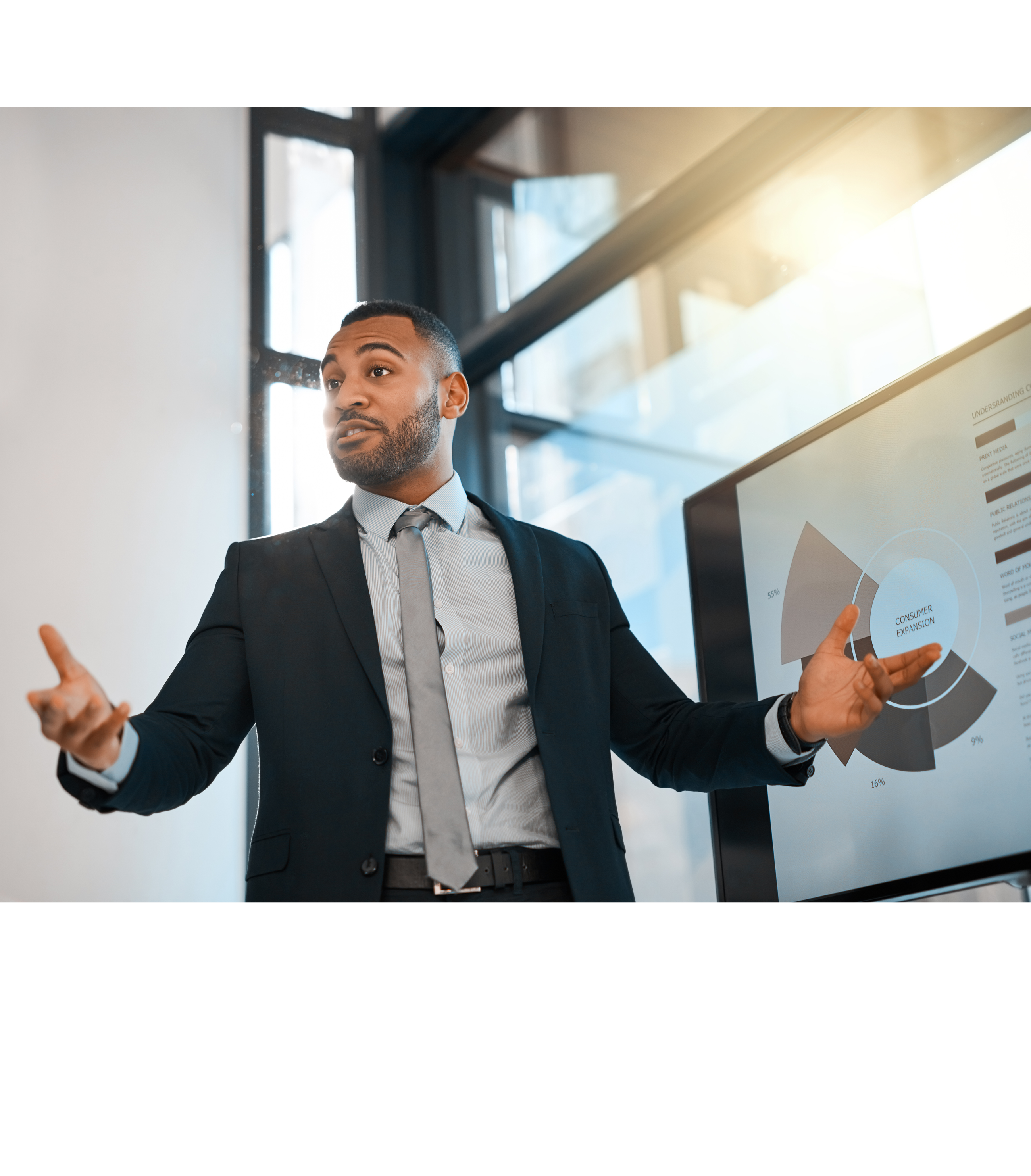 Shot of a young businessman presenting data on a screen during a meeting in an office
