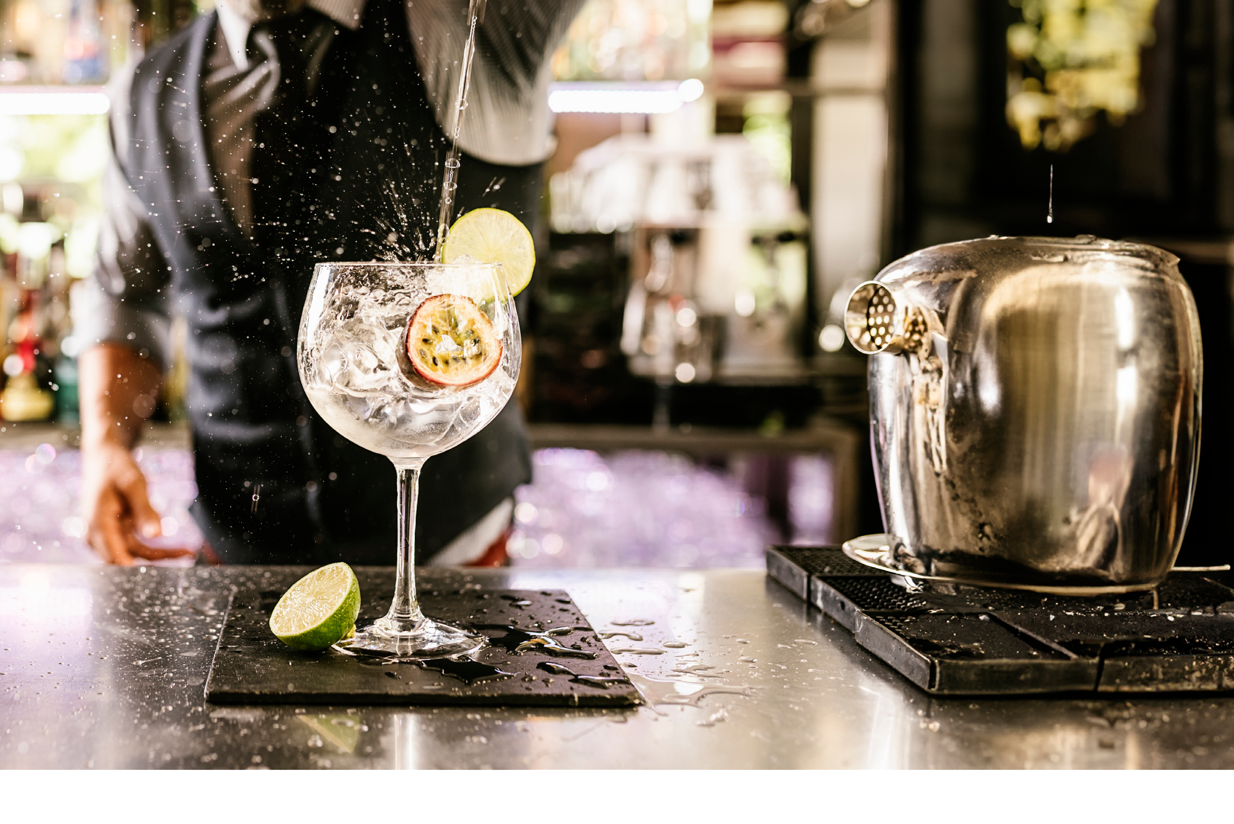 Expert barman is making cocktail at night club.