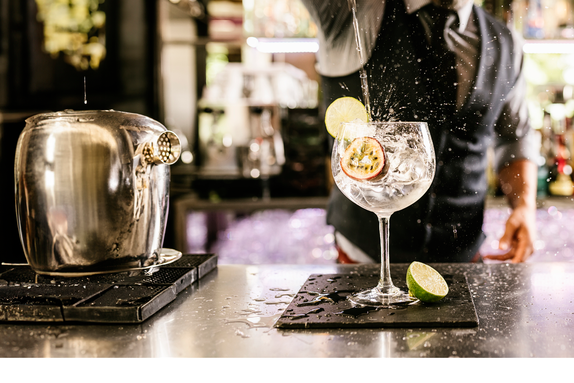 Expert barman is making cocktail at night club.