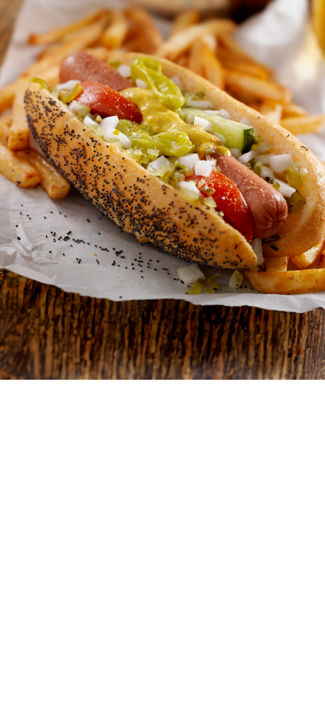A Classic Chicago Dog with Fries and a Beer - The Chicago Dog has a Steamed Poppyseed Bun, Fresh Tomatoes, Diced Onions, Neon Green Relish,Peppers,Pickle, Yellow Mustard and a Dash of Celery Salt- Photographed on Hasselblad H3D2-39mb Camera