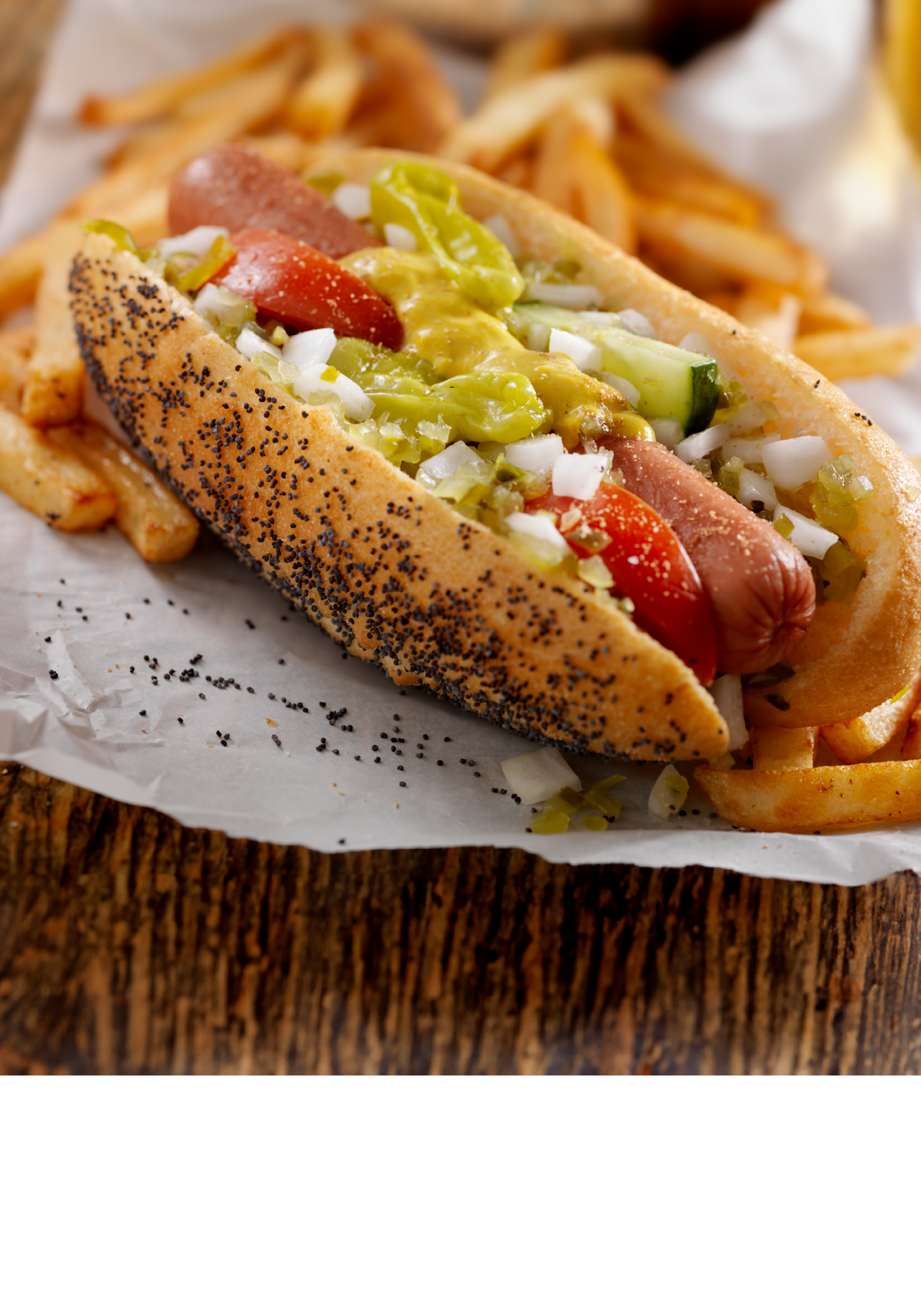 A Classic Chicago Dog with Fries and a Beer - The Chicago Dog has a Steamed Poppyseed Bun, Fresh Tomatoes, Diced Onions, Neon Green Relish,Peppers,Pickle, Yellow Mustard and a Dash of Celery Salt- Photographed on Hasselblad H3D2-39mb Camera
