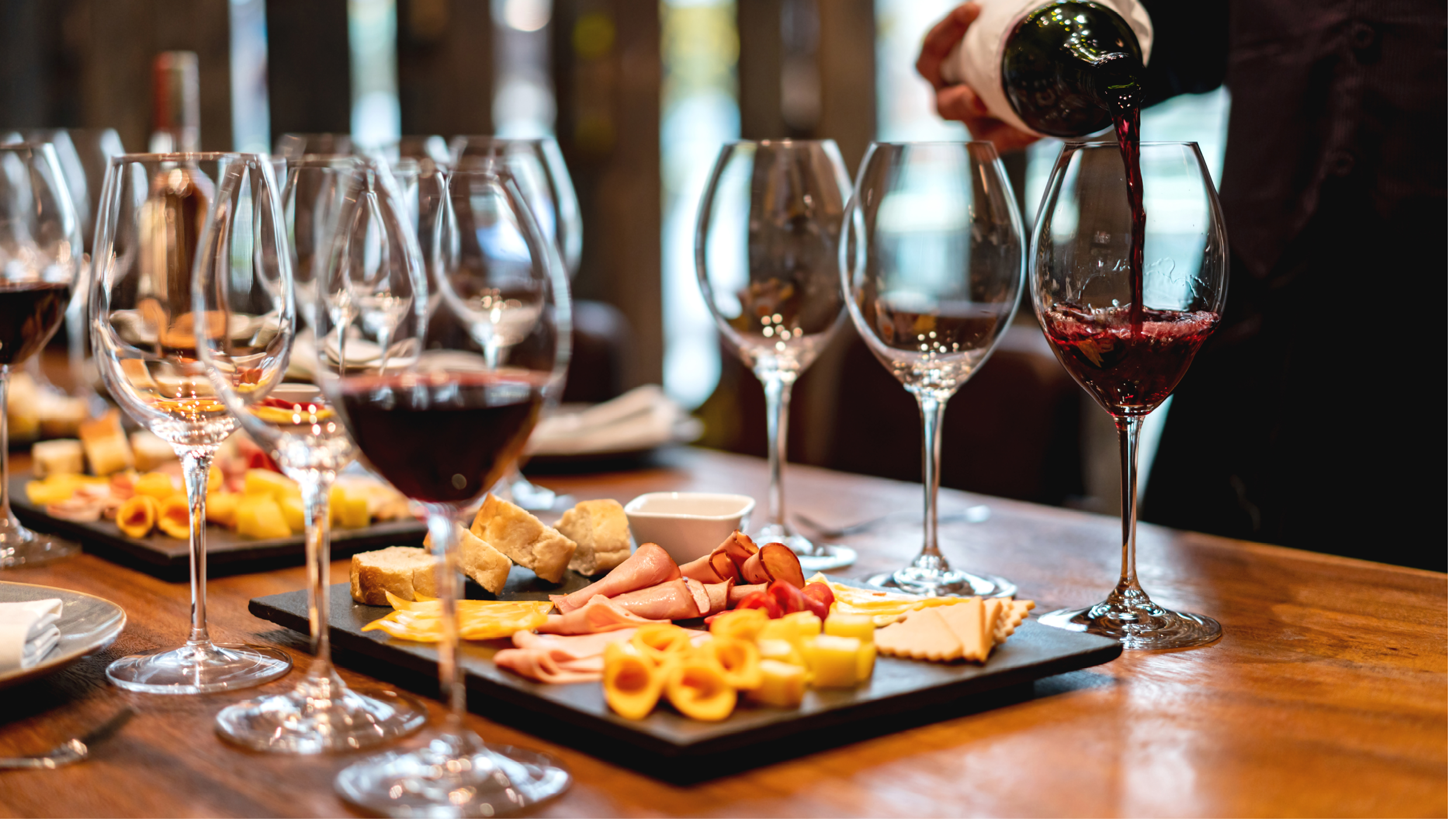 Close-up on a sommelier serving glasses of winetasting event