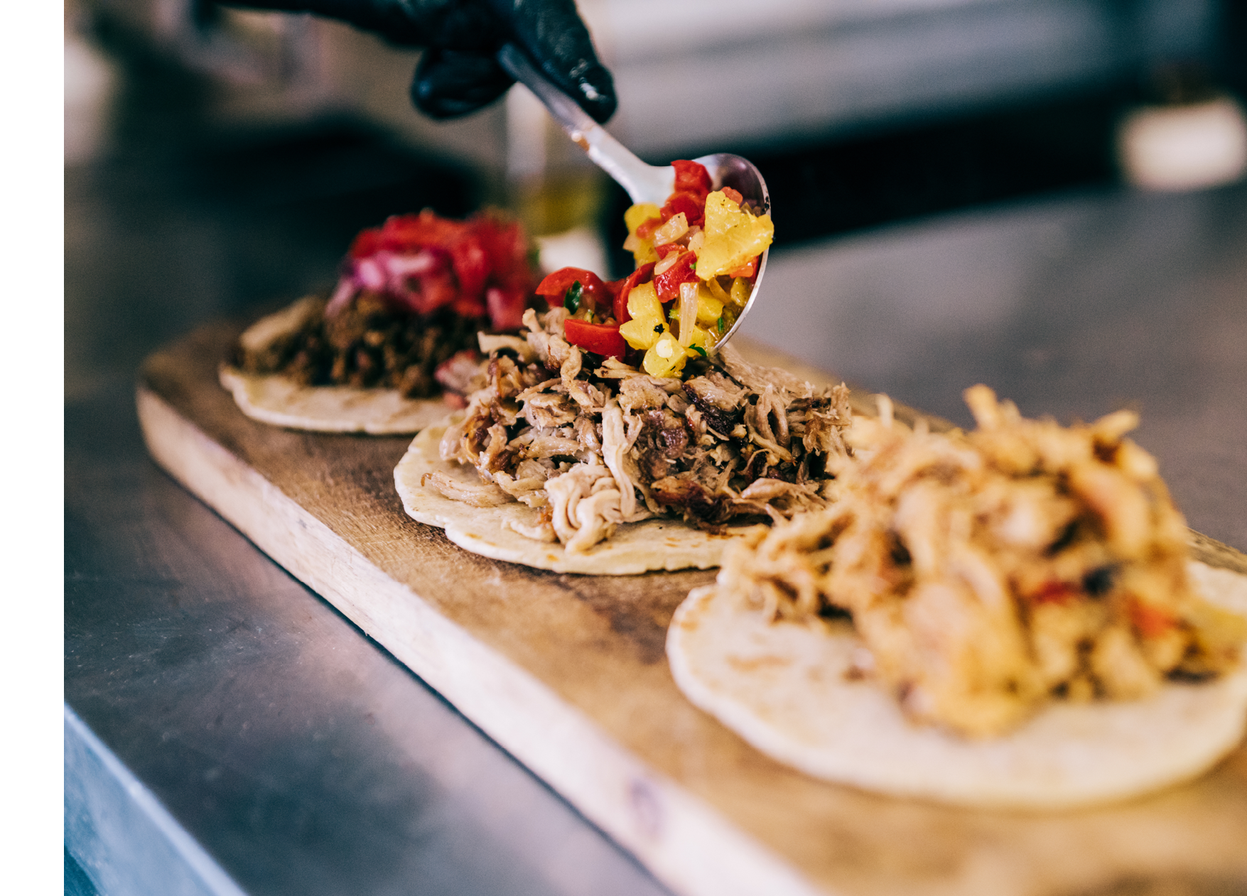 Shot of young chef preparing tacos in a food truck.