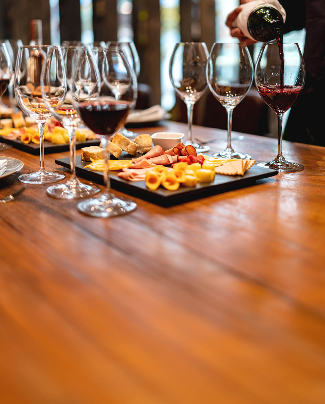 Close-up on a sommelier serving glasses of winetasting event