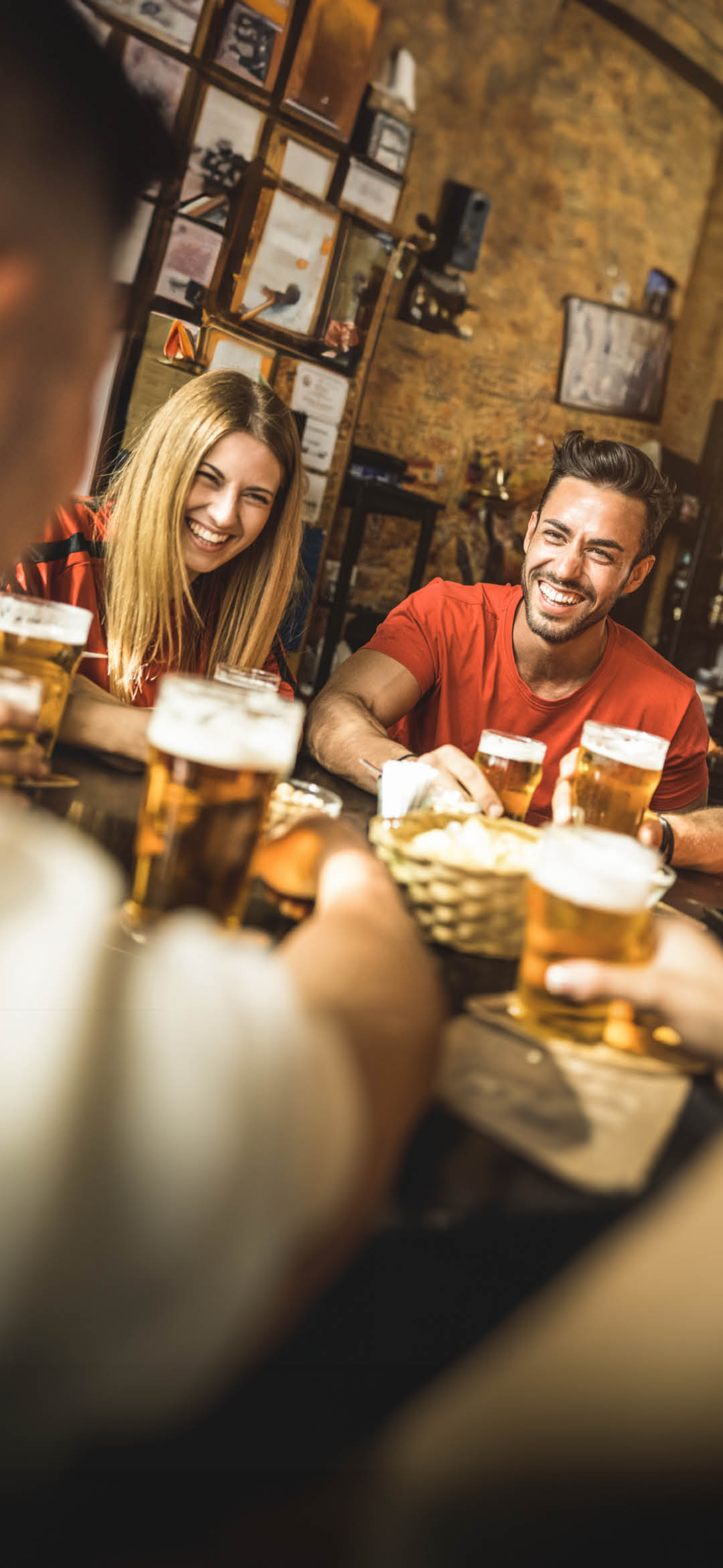 Happy friends group drinking beer at brewery bar restaurant - Friendship concept with young people enjoying time together and having genuine fun at cool vintage pub - Focus on guy - High iso image