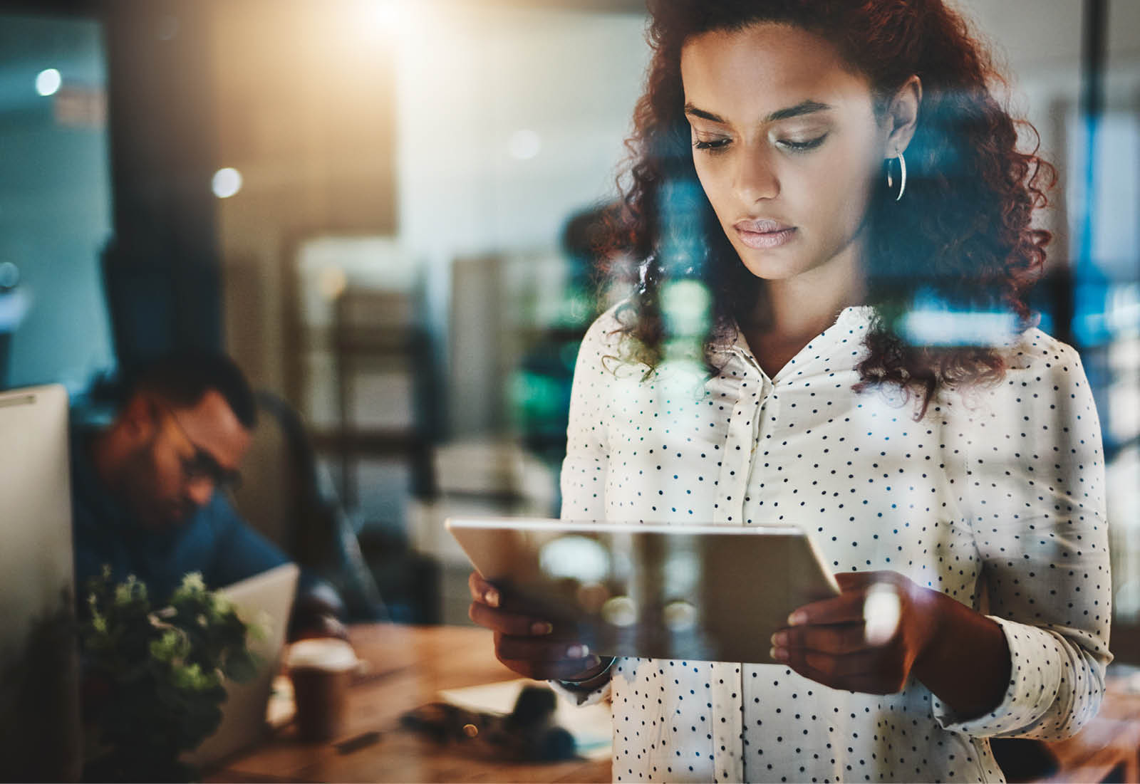 Shot of a young businesswoman using a digital tablet during a late night at work