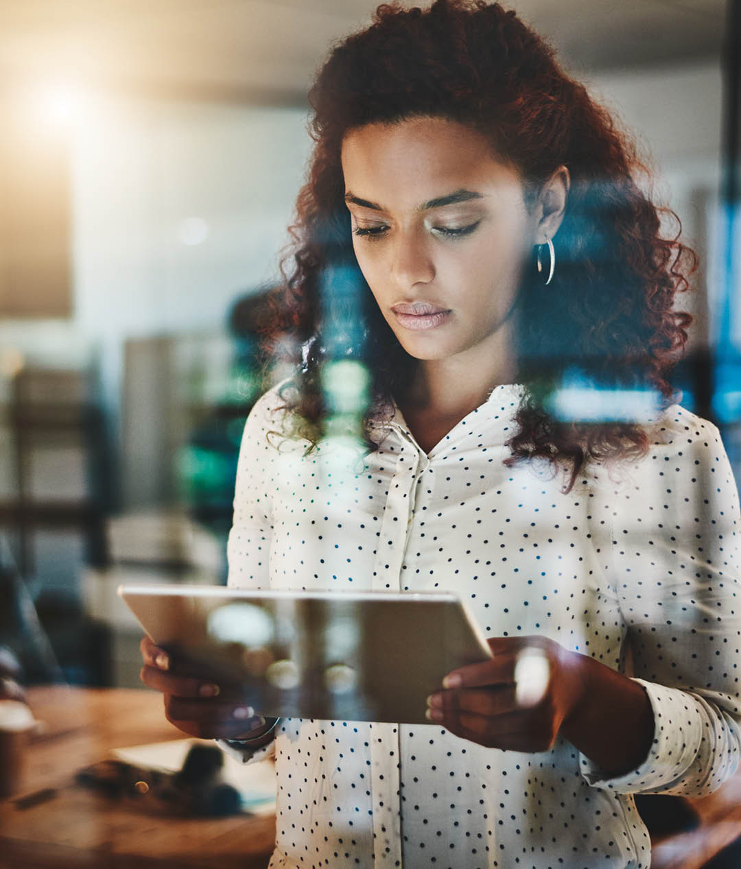 Shot of a young businesswoman using a digital tablet during a late night at work