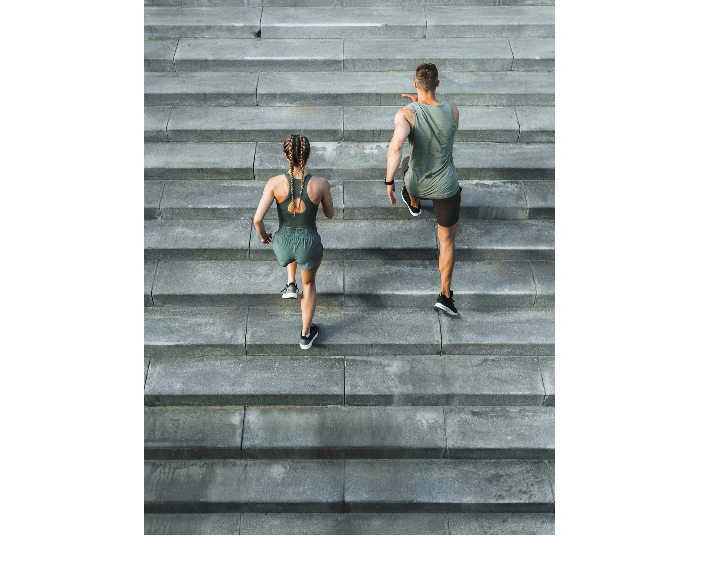 Young sportive couple during workout stair running outdoors