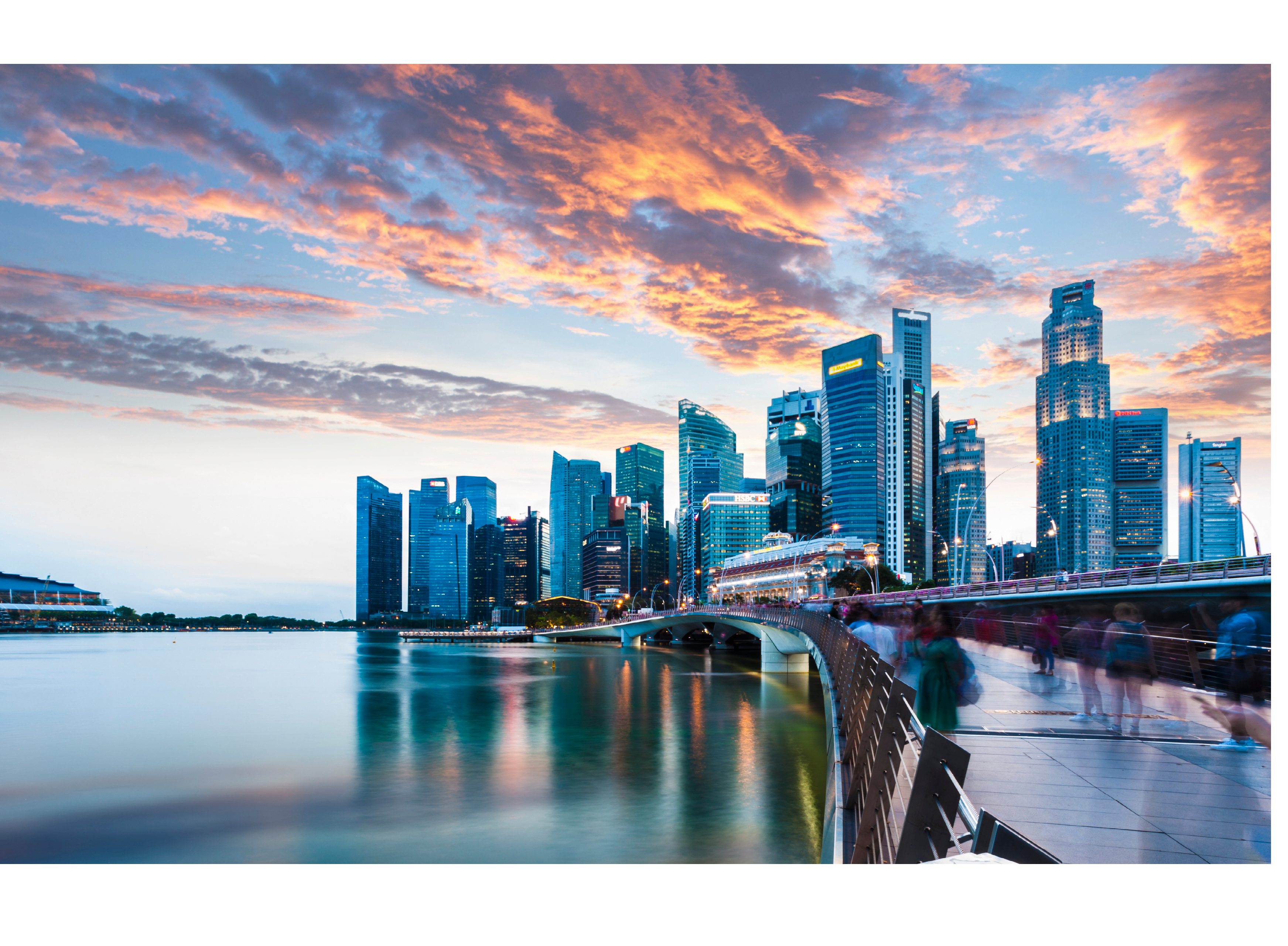 Singapore Skyline at Marina Bay at Twilight with glowing sunset illuminating the clouds