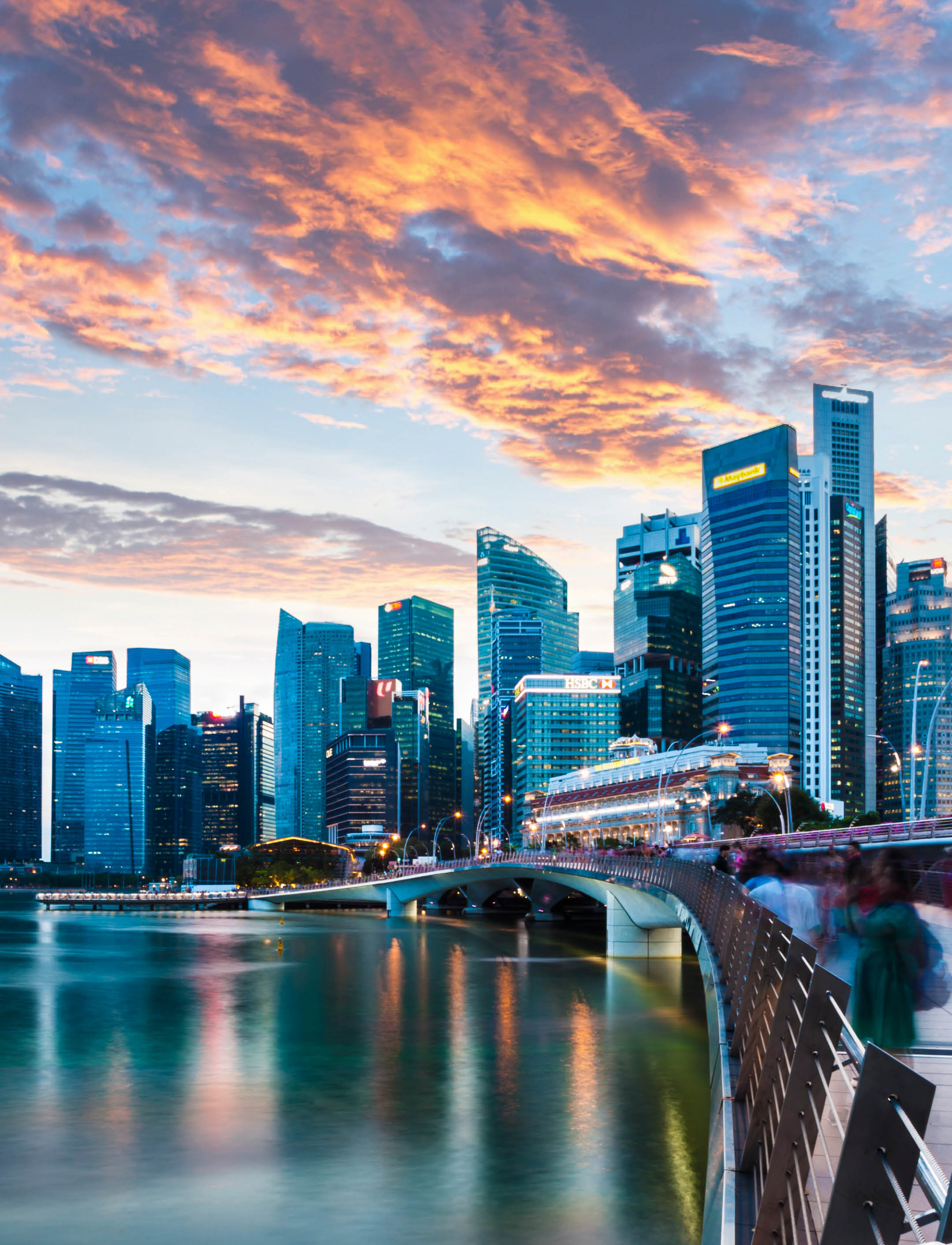 Singapore Skyline at Marina Bay at Twilight with glowing sunset illuminating the clouds