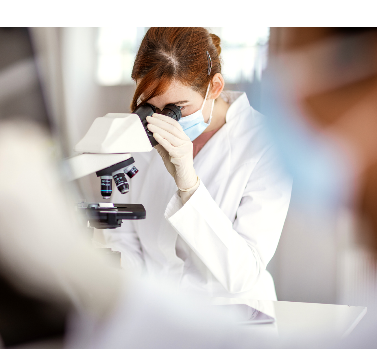 Scientist looking through a microscope