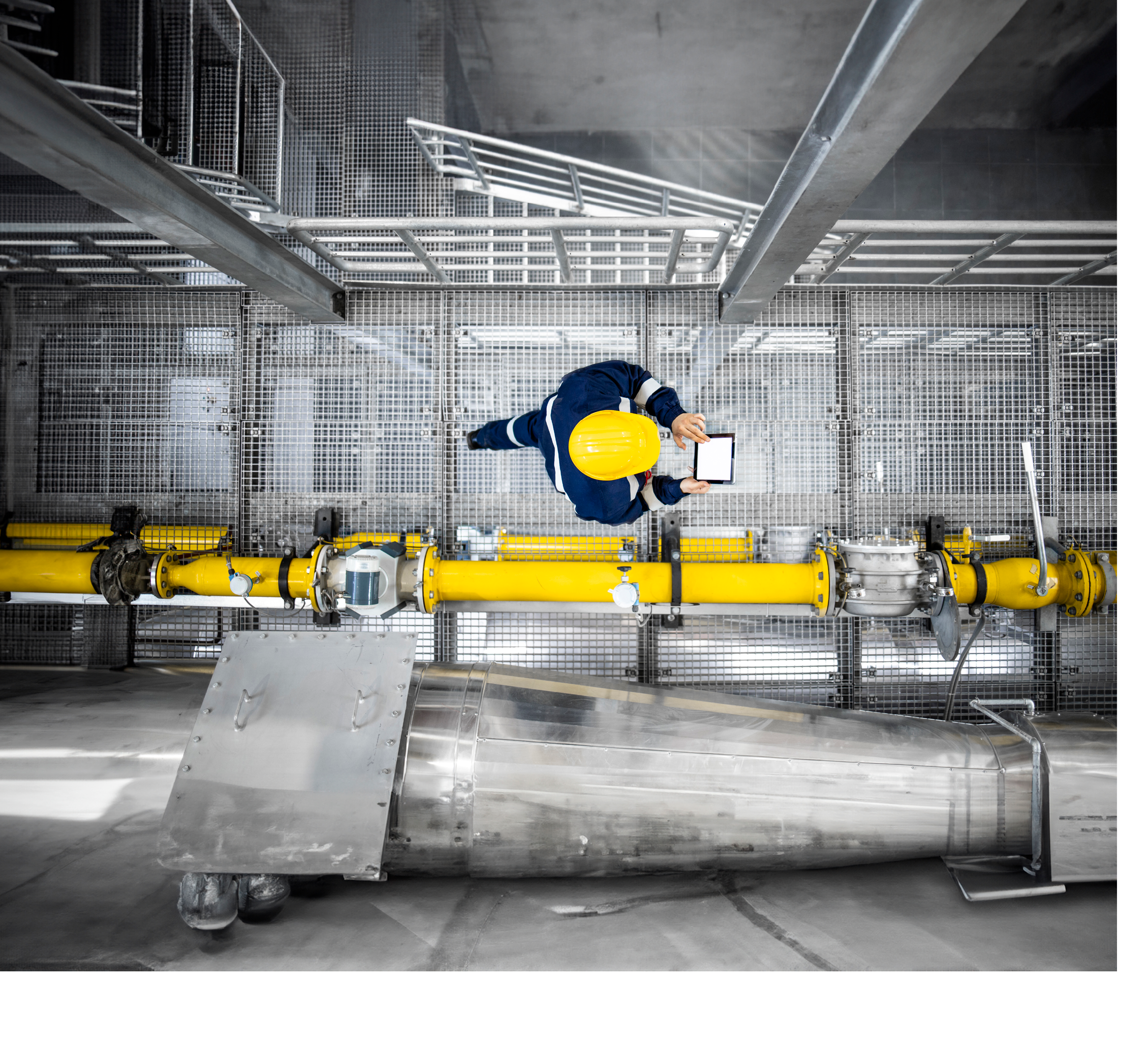 Top view of refinery worker walking by gas pipes, checking gasoline supply and installations in production plant.