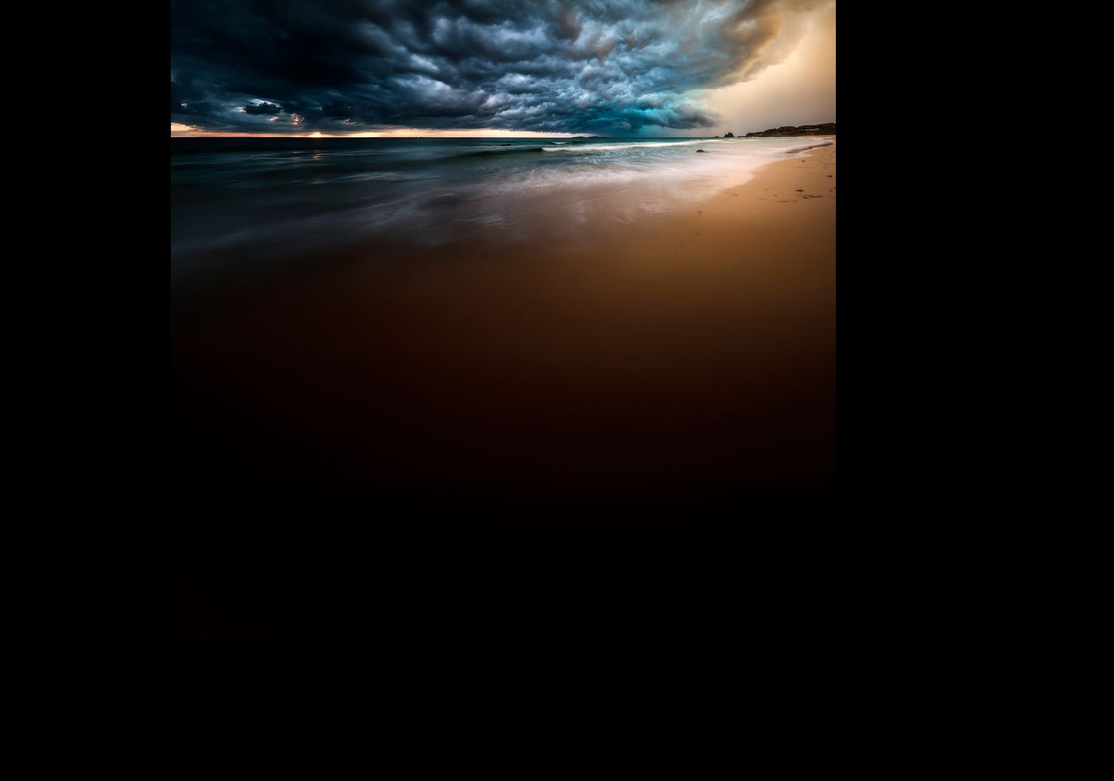 Powerful dramatic storm cell over ocean beach with golden light, Australia