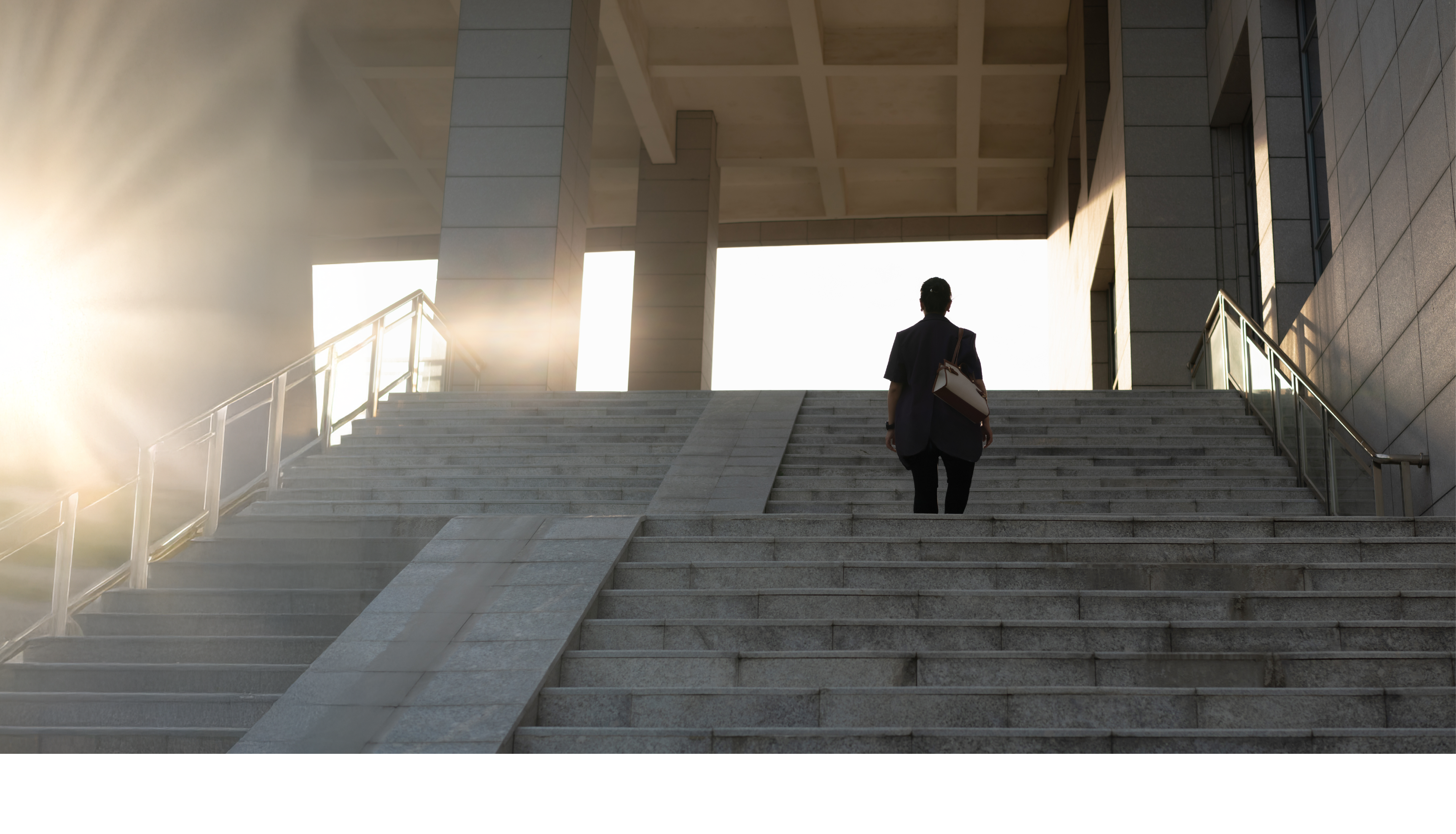 lady walking up stairs in sunlight