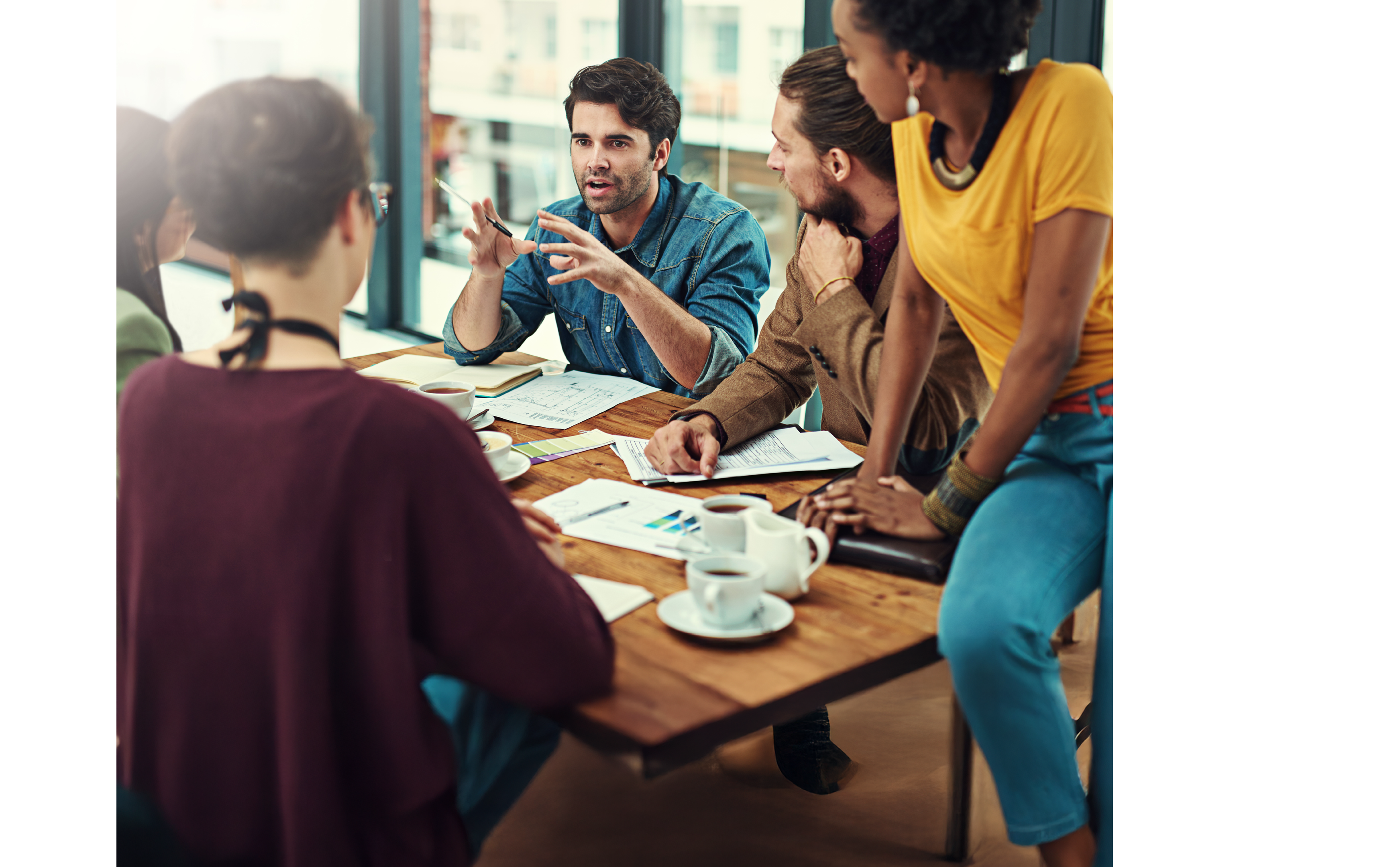 Cropped shot of a group of young creatives having a meeting in a modern office