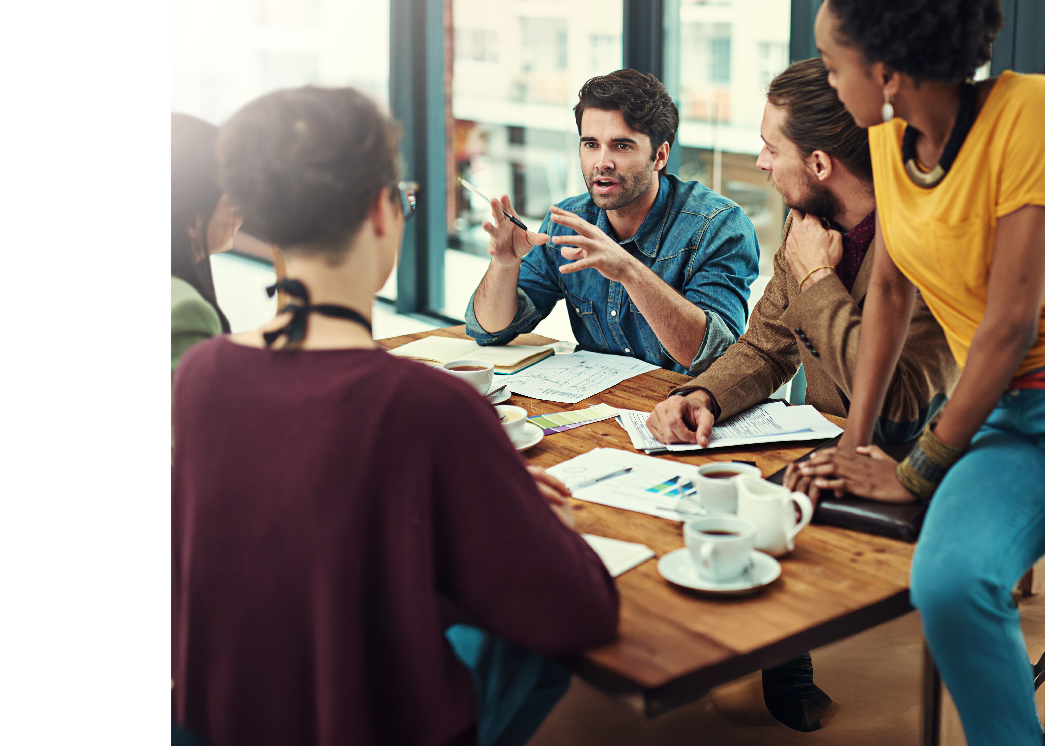 Cropped shot of a group of young creatives having a meeting in a modern office