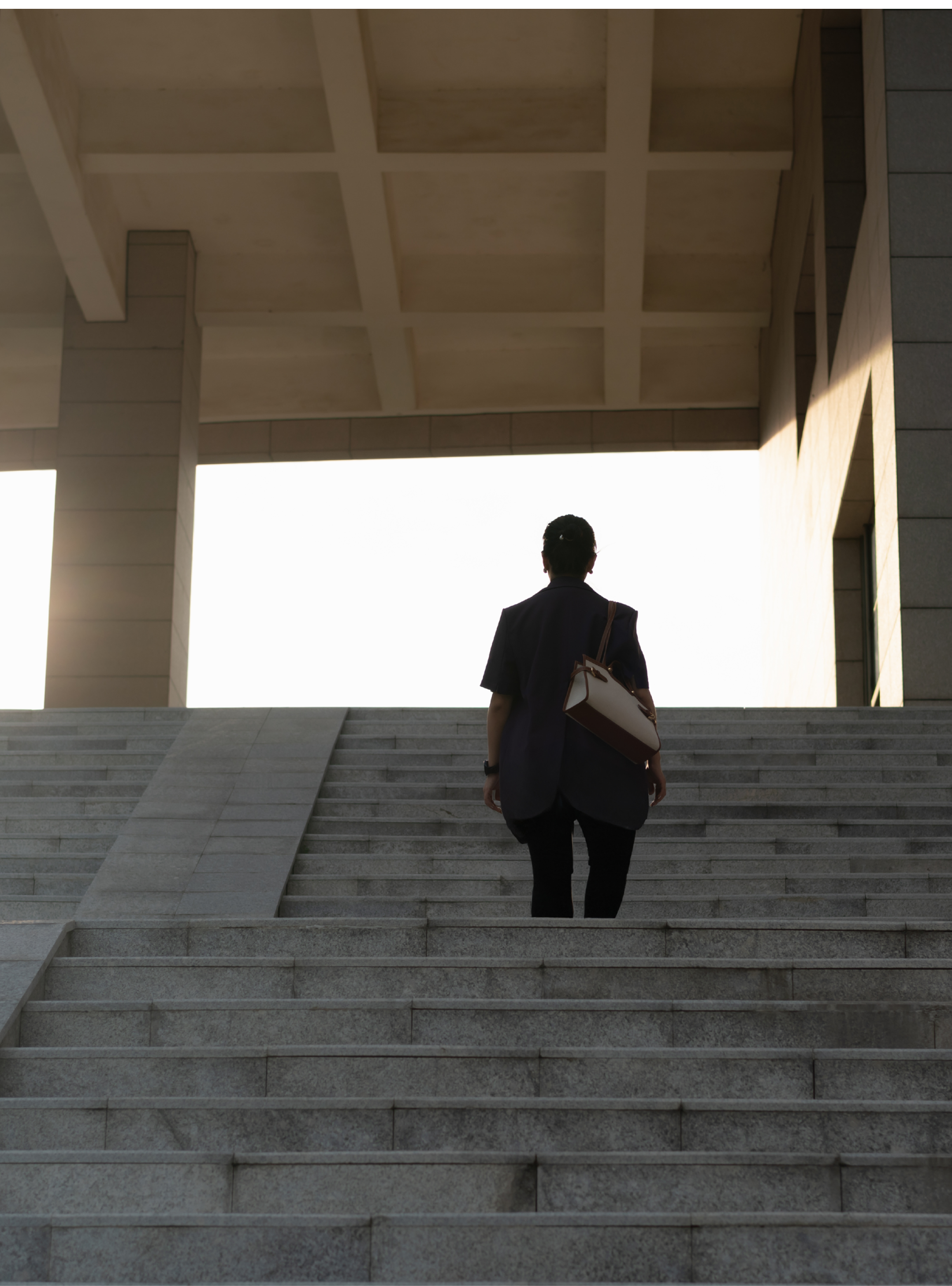 lady walking up stairs in sunlight