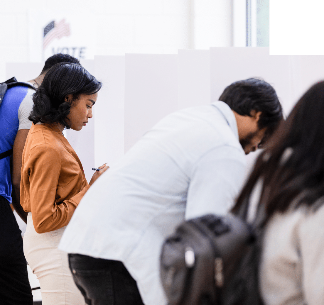 The young adult female businesswoman reads her ballot carefully before making her selections.