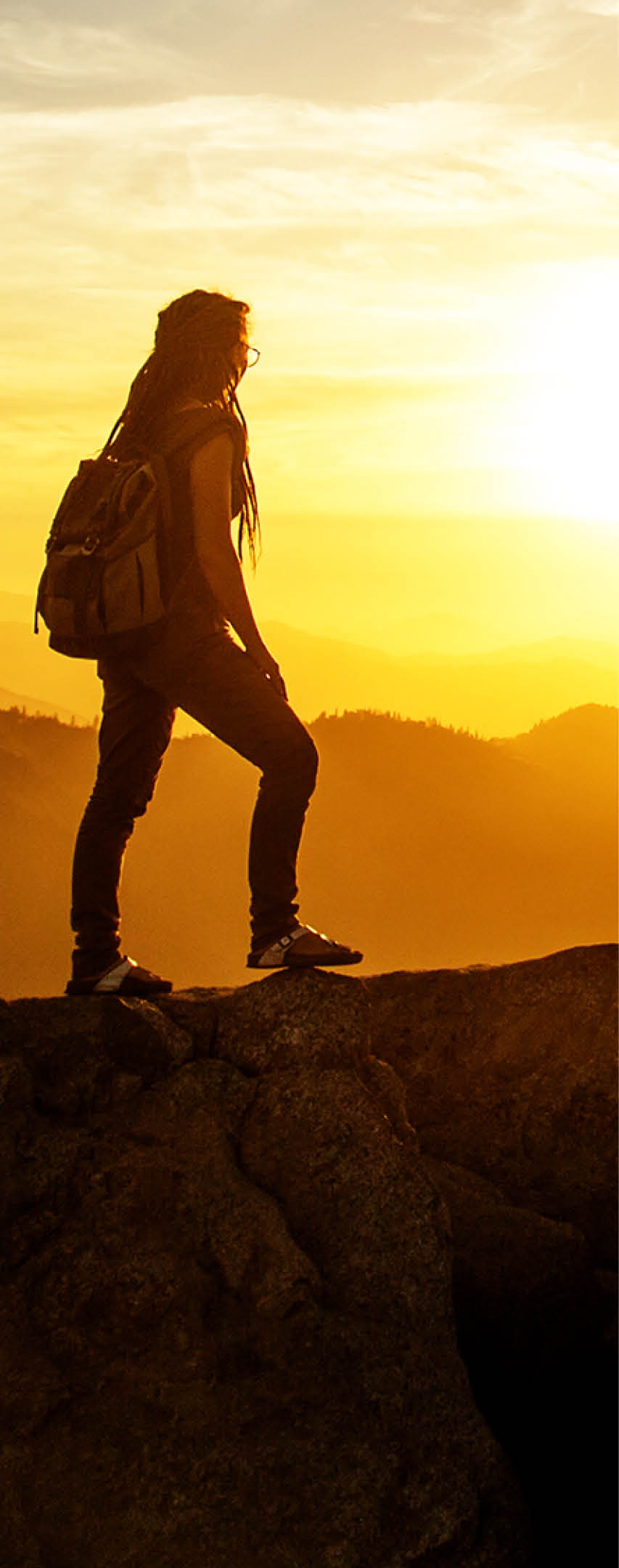Hiker meets the sunset on the Moro rock in Sequoia national park, California, USA.