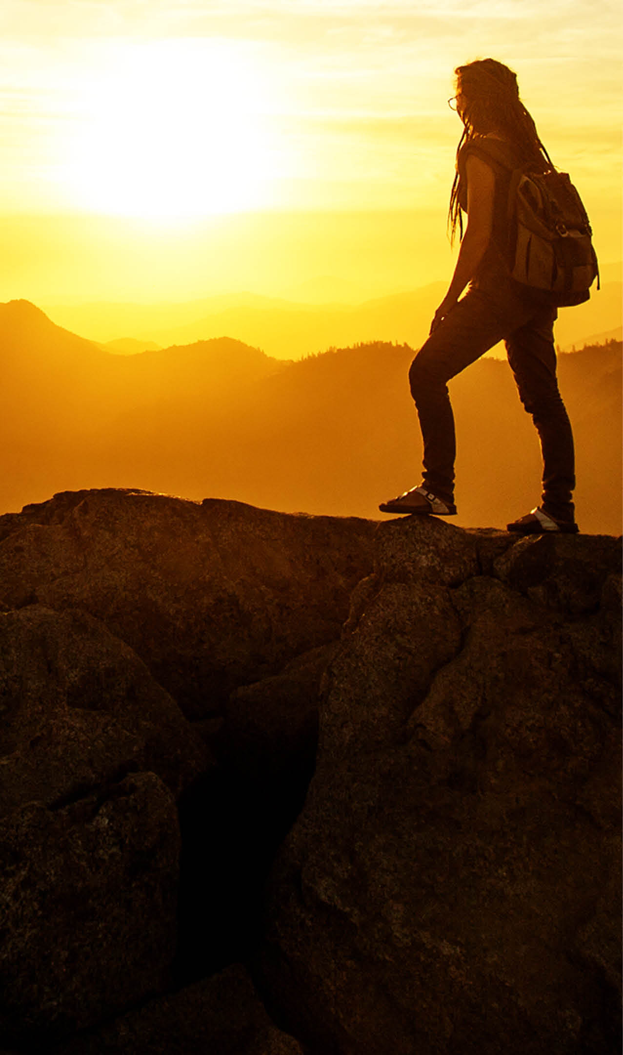 Hiker meets the sunset on the Moro rock in Sequoia national park, California, USA.