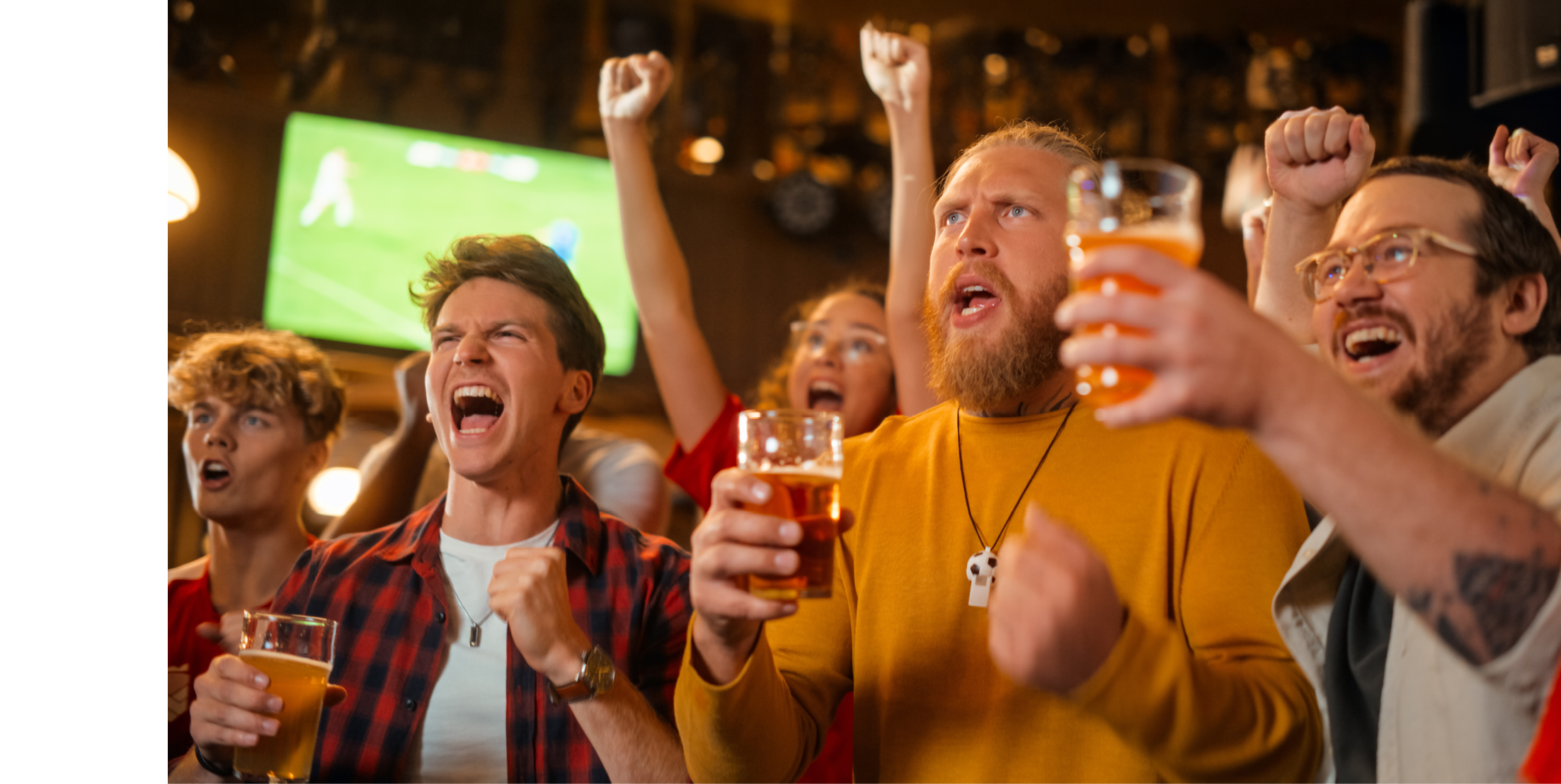 Soccer Club Members Cheering for Their Team, Drinking Beer in a Pub. Supportive Fans Standing in a Bar, Cheering, Raising Glasses and Shouting. Friends Celebrate Victory After the Goal.