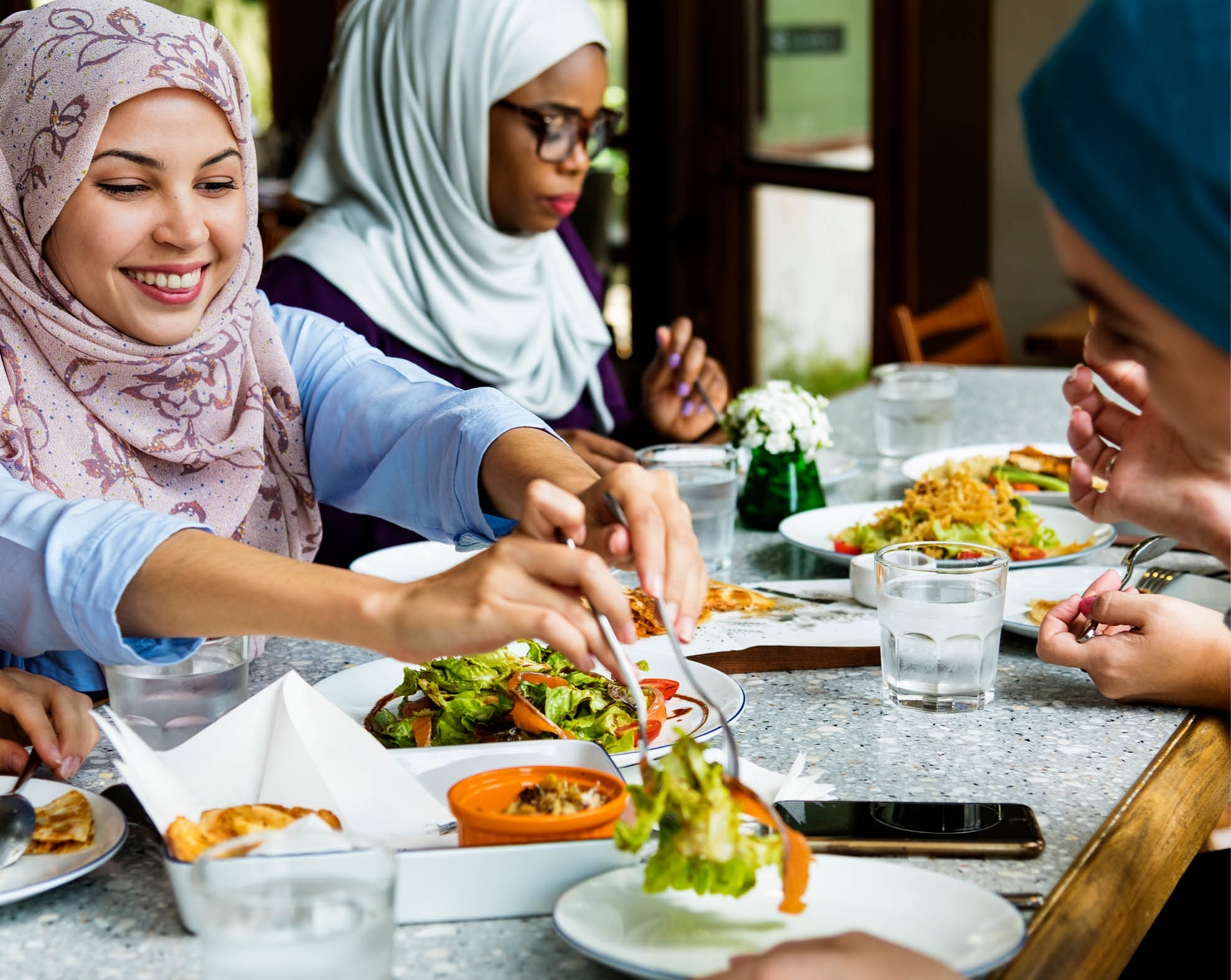 Islamic women friends dining together with happiness
