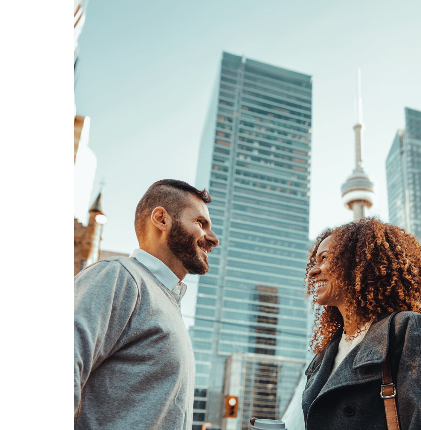 Two people standing in front of a city skyline, smiling and enjoying their time together. AI generated content